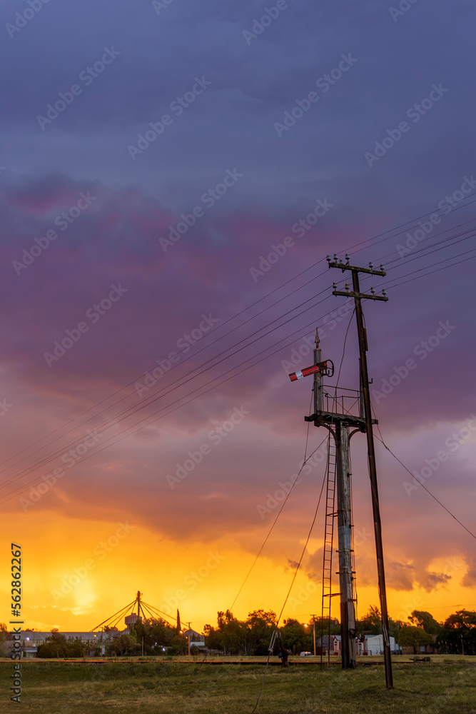 Fototapeta premium railway signal with impressive stormy sky at sunset. vertical format
