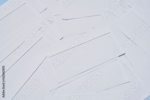 several pieces of white paper on a blue background with copy space in the top right corner, and bottom left corner