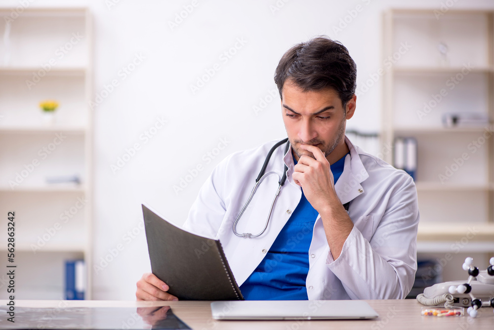 Young male doctor working in the clinic Young male doctor working in the clinic