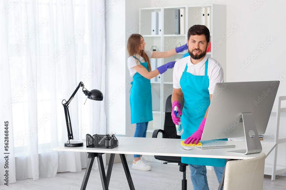 Young janitors cleaning in modern office Young janitors cleaning in modern office