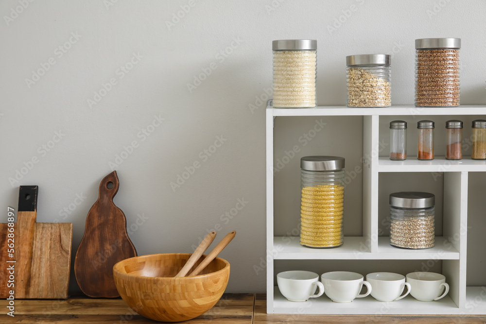 Jars with cereals, spices and utensils on kitchen counter Jars with cereals, spices and utensils on kitchen counter