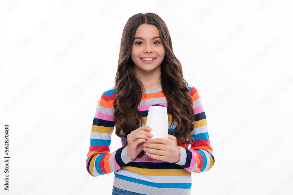 Child with shampoo conditioner. Daily cosmetic care. Teenager kid 12, 13, 14 years old hold bottle of hair and skin care. Beauty health and cosmetics. Happy girl face, positive and smiling emotions. Child with shampoo conditioner. Daily cosmetic care. Teenager kid 12, 13, 14 years old hold bottle of hair and skin care. Beauty health and cosmetics. Happy girl face, positive and smiling emotions.