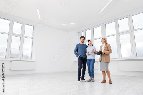 Real estate agent showing new apartment to couple