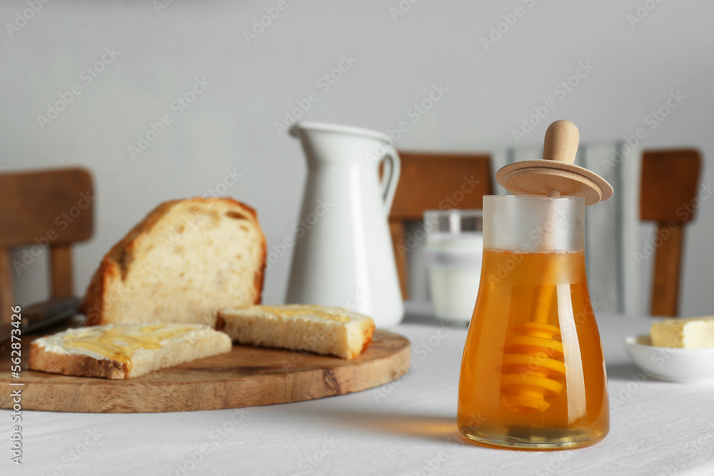 Delicious honey, milk and bread with butter served for breakfast on table Delicious honey, milk and bread with butter served for breakfast on table