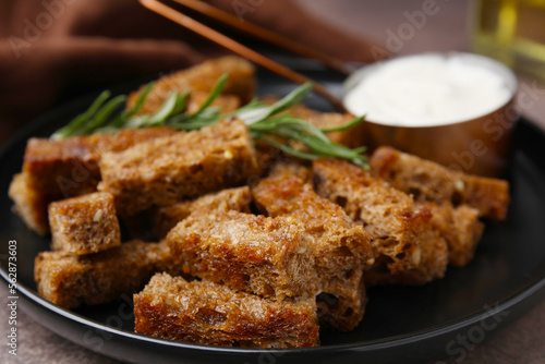 Crispy rusks with rosemary on plate, closeup