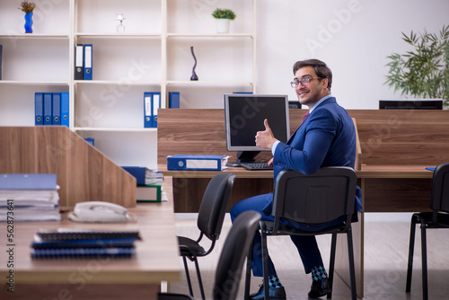 Young male employee working in the office