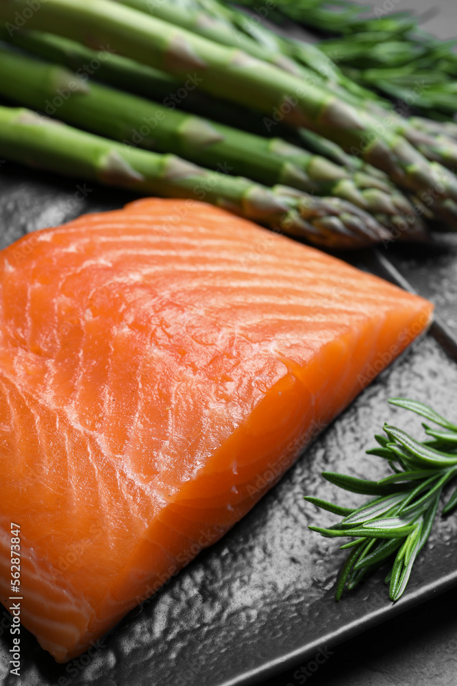 Fresh raw salmon and ingredients for marinade on black table, closeup Fresh raw salmon and ingredients for marinade on black table, closeup
