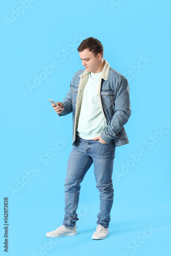 Young man in denim jacket u...
