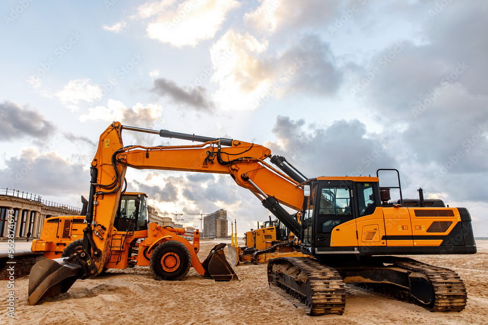 Excavator prepares the sea beach for the season.