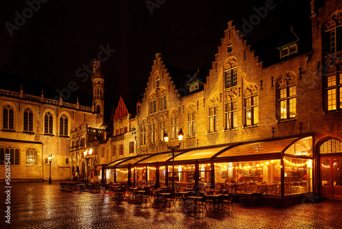 Restaurant with a terrace in the old Europe town square on a rainy night.