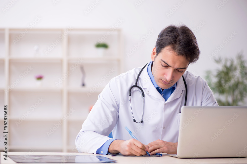 Young male doctor working in the clinic Young male doctor working in the clinic