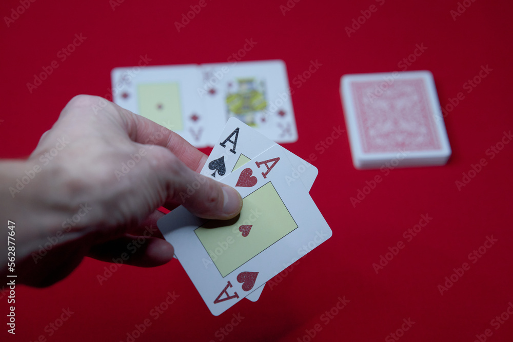 Obraz premium player shows two play card aces on a red table in a casino. gambling