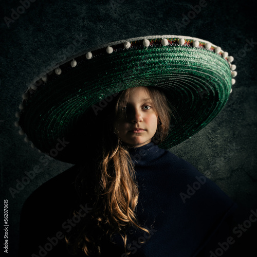 Portrait of a cute little girl wearing a sombrero