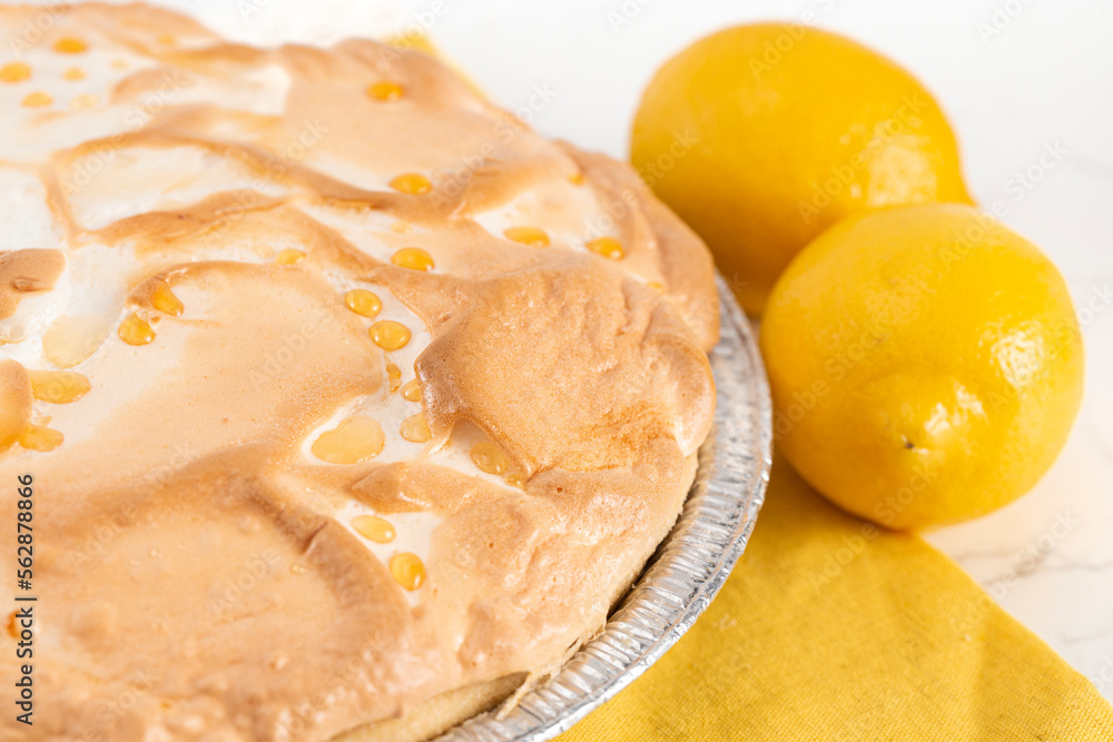 Whole Fresh Lemon Meringue Pie on a Kitchen Counter Whole Fresh Lemon Meringue Pie on a Kitchen Counter