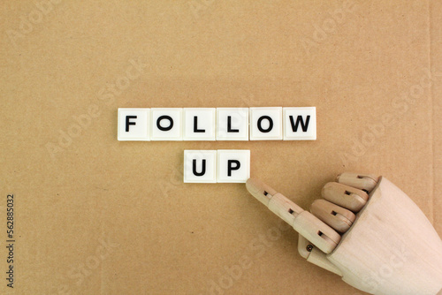wooden hand with follow-up words. the concept of follower or follower. follow-up concept © Fauzi
