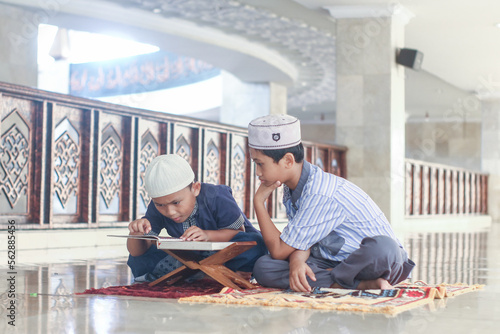 Muslim boys recite the Koran in the mosque photo