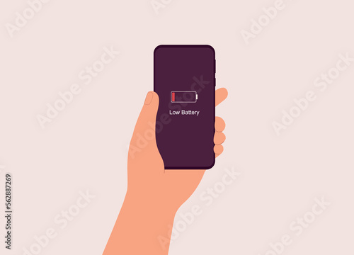 A Males’s Hand Holding Mobile Phone With Low Battery Icon Showing Up On The Device Screen. Close-Up. Flat Design Style, Character, Cartoon.