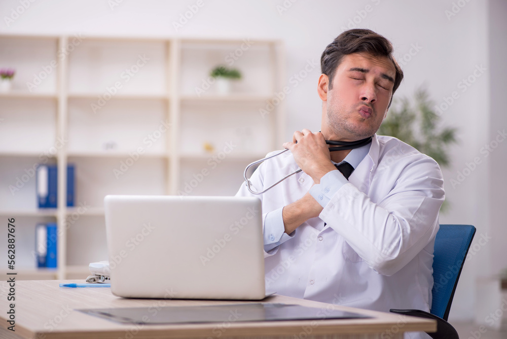 Young male doctor working in the clinic Young male doctor working in the clinic