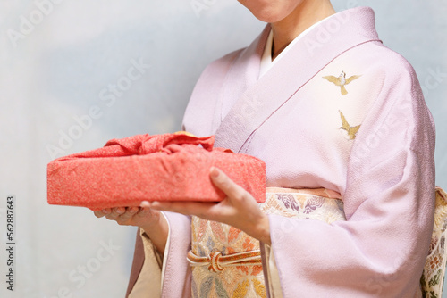 風呂敷包みを持つ着物姿の女性　顔なし