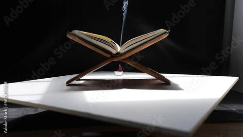 Slow motion The Quran in the mosque is placed on a wooden board. ,Is an important book of Muslims in Islam.Black background.