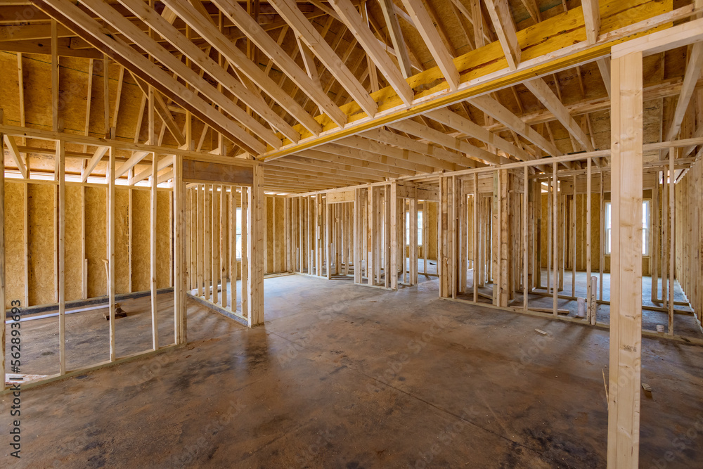 This an interior framing newly constructed house under construction, which is framed with truss beams