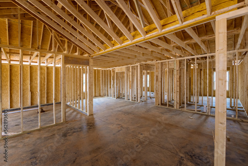 This an interior framing newly constructed house under construction  which is framed with truss beams