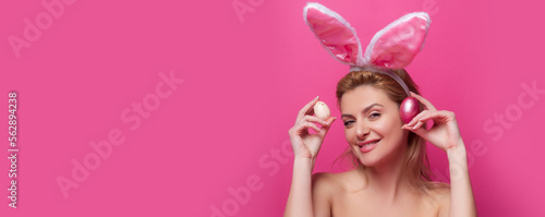 Smiling bunny girl. Happy easter. Pinup style isolated on pink banner, copy space. Panoramic web banner frame.