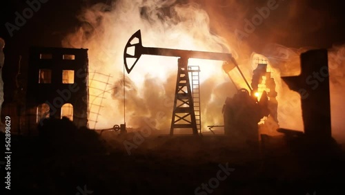 Artwork decoration. Oil war concept. Military silhouettes at oilfield with pumps and rigs. Misty colorful sky background. Armored vehicles fighting scene. Selective focus