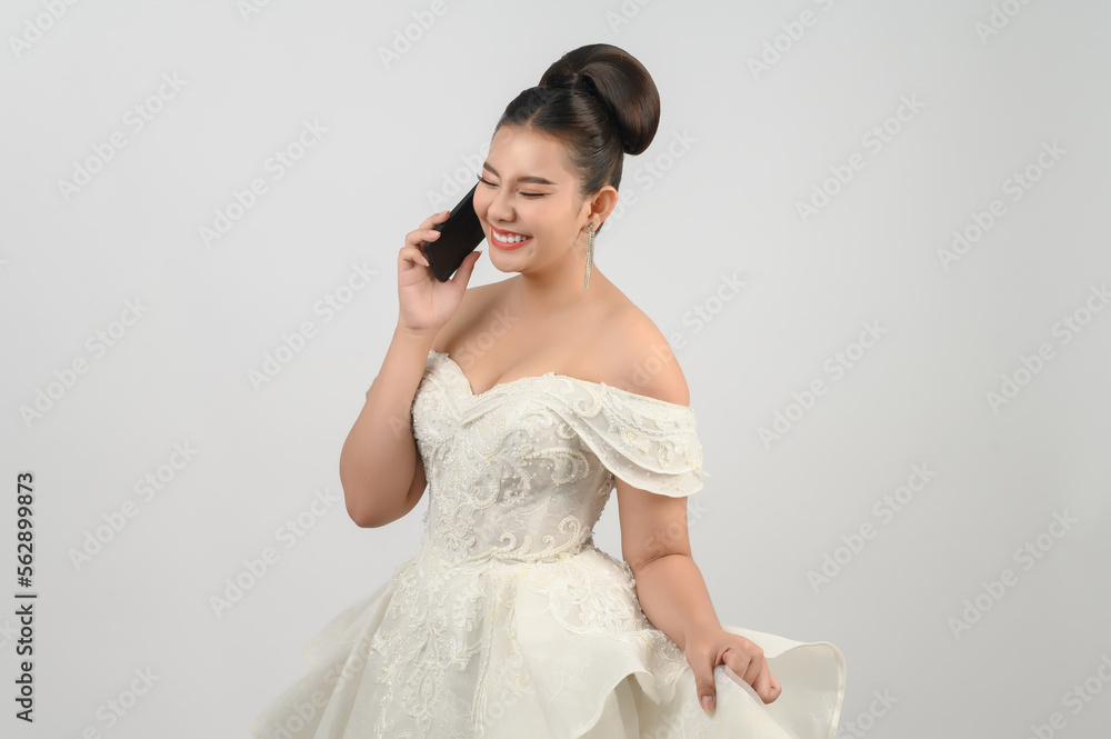 Young asian beautiful bride posting with smartphone in hand Young asian beautiful bride posting with smartphone in hand
