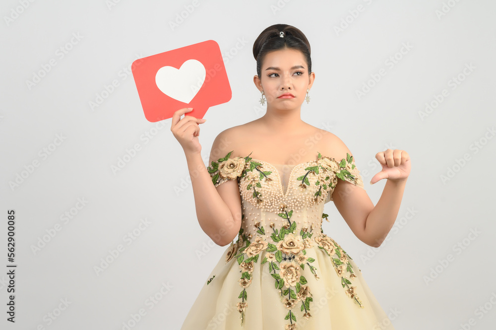 Asian beautiful bride smiling and posing with heart sign on white background