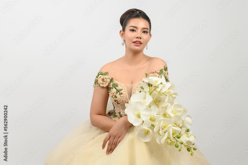 Young asian beautiful bride with orchid bouquet on white background Young asian beautiful bride with orchid bouquet on white background