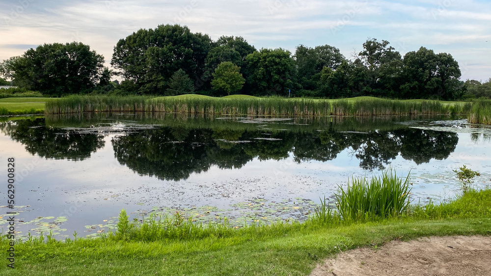 Fototapeta premium golf green over the pond