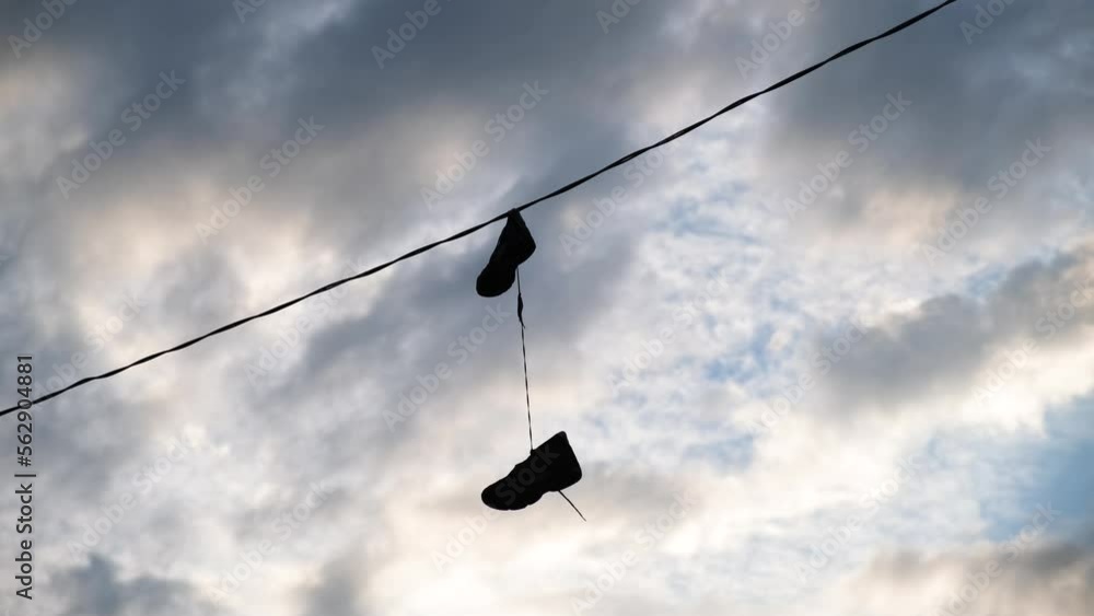 Shoes Hanging From Wire In Urban Setting Shoes Hanging From Wire In Urban Setting