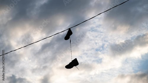 Shoes Hanging From Wire In Urban Setting
