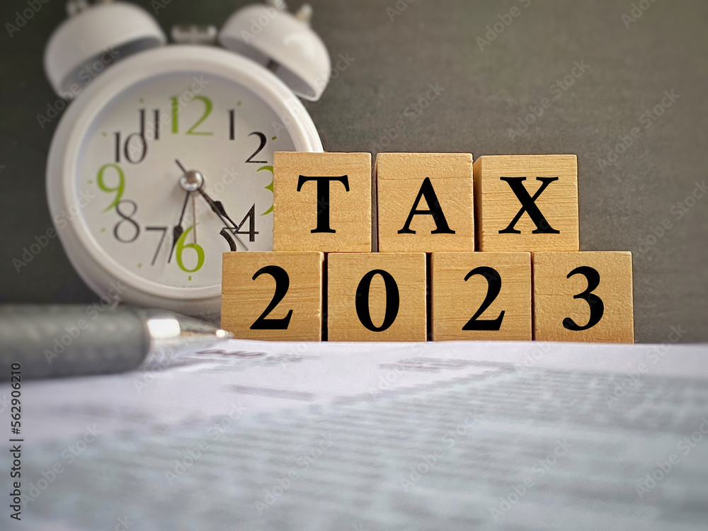 Φωτογραφία Tax 2023 word on wooden blocks background. Tax filing concept.