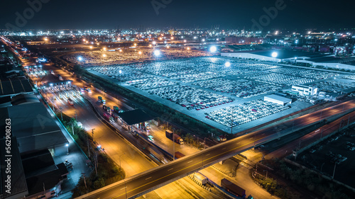 night scene shot over lighting new cars lined up at Industrial factory and commercial port