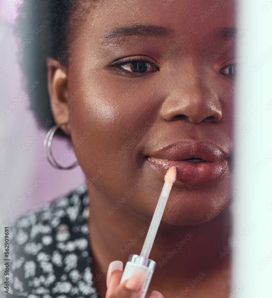 Black woman, makeup and lipstick for beauty, cosmetics or glow and gloss for facial treatment in the bathroom. African American female applying cosmetic product to lips or mouth with stick brush Black woman, makeup and lipstick for beauty, cosmetics or glow and gloss for facial treatment in the bathroom. African American female applying cosmetic product to lips or mouth with stick brush