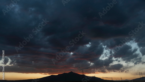 sunset view and cloudy sky with dramatic clouds, sunset over mountains