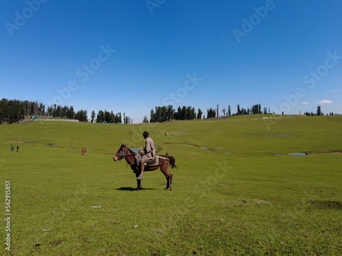 Kashmir, India - April 26 2021 : Local man on horse in kashmir