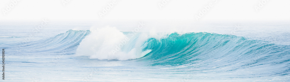 (Selective focus) Stunning view of some ocean waves breaking on the shore during a beautiful sunny day. Crushing waves, ocean waves relaxation. Bali, Indonesia.