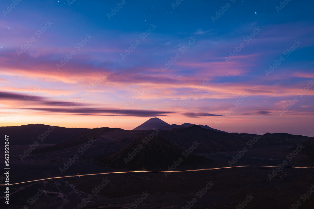 View from above, stunning panoramic view of the Mt Batok, Mt Bromo and the Mt Semeru in the distance illuminated during a dramatic sunrise. Mount Bromo is an active volcano in East Java, Indonesia.