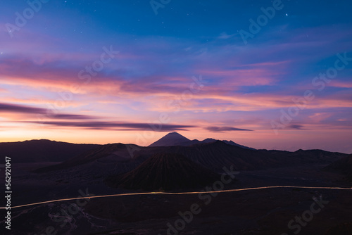 Obraz na płótnie View from above, stunning panoramic view of the Mt Batok, Mt Bromo and the Mt Semeru in the distance illuminated during a dramatic sunrise. Mount Bromo is an active volcano in East Java, Indonesia. w salonie