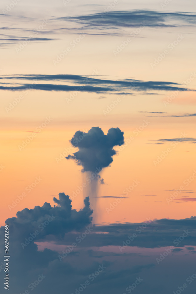 Stunning dramatic sky with some clouds and a cumulonimbus cloud producing torrential rain. Sunset, romantic sky, natural background, climate changes concept.
