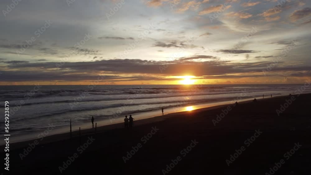 People enjoying the beauty of the sunset on the beach of indonesia. Drone view People enjoying the beauty of the sunset on the beach of indonesia. Drone view