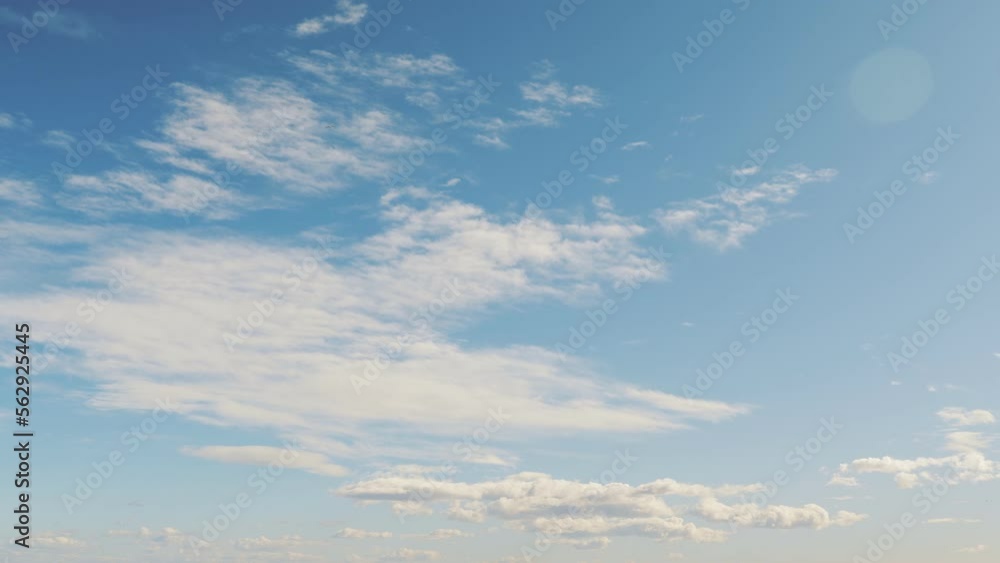 White fluffy clouds moving fast against blue sky.Amazing cloudscape at sunny day White fluffy clouds moving fast against blue sky.Amazing cloudscape at sunny day
