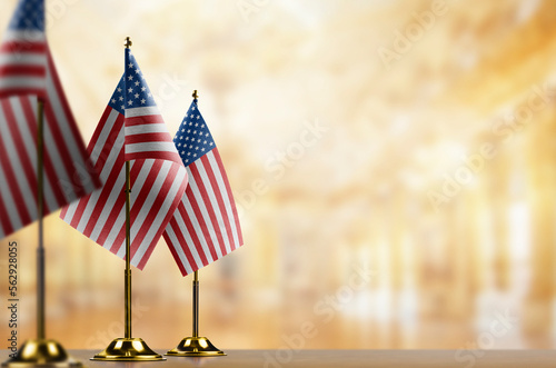 Small flags of the USA on an abstract blurry background