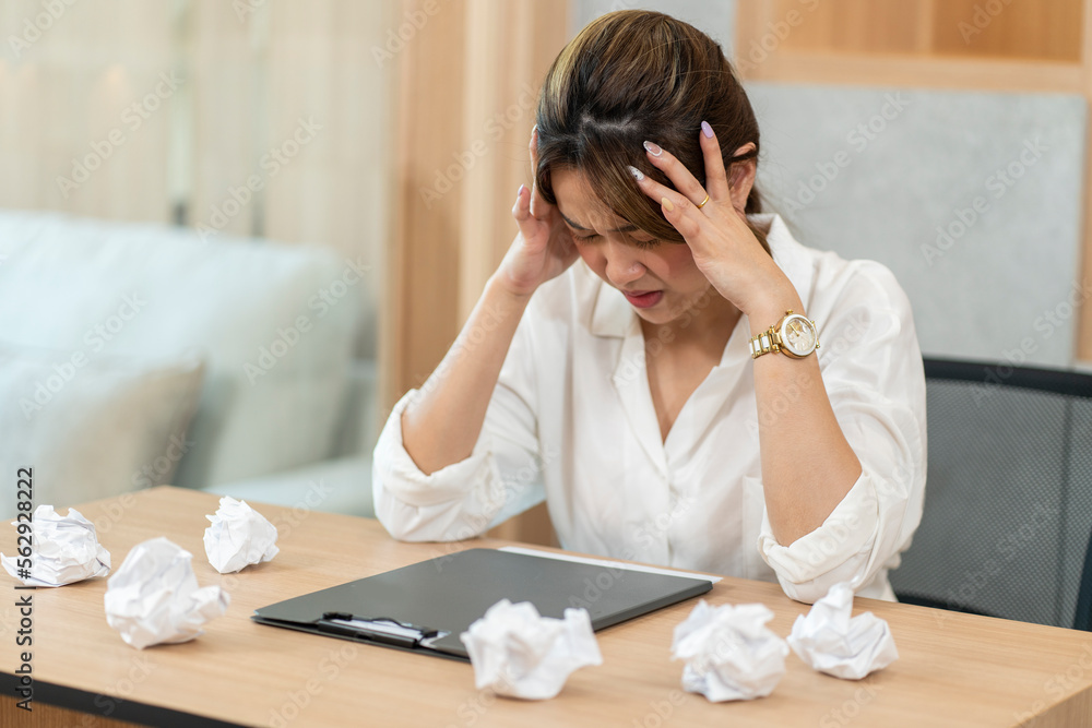Young Asian businesswoman working hard, tired, headache, frustrated at work. Office Syndrome Concept Young Asian businesswoman working hard, tired, headache, frustrated at work. Office Syndrome Concept