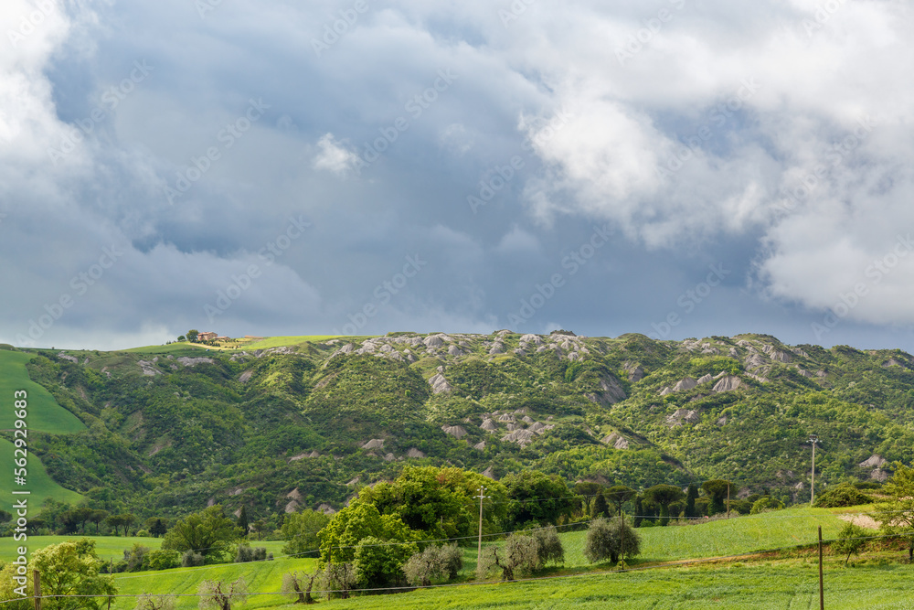Beautiful Tuscan landscape view with storm clouds in the sky
