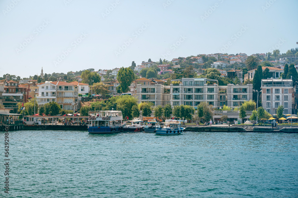 Panoramic sea view of the resort town with houses in the mountains and a pier  with boats on a Adalar Islands