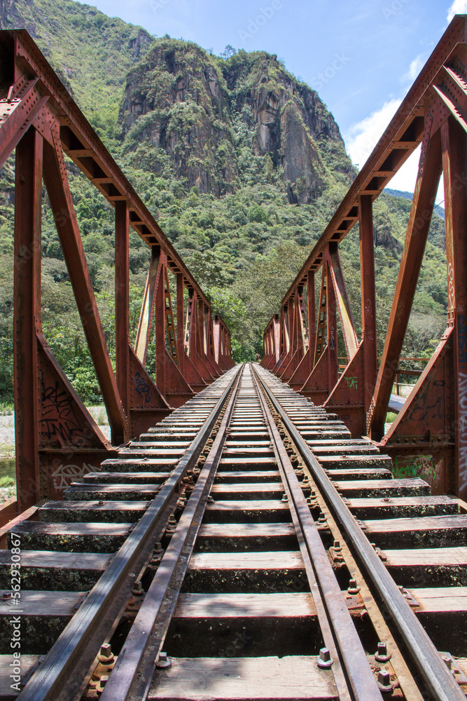 Railroad track on bridge against mountains Railroad track on bridge against mountains